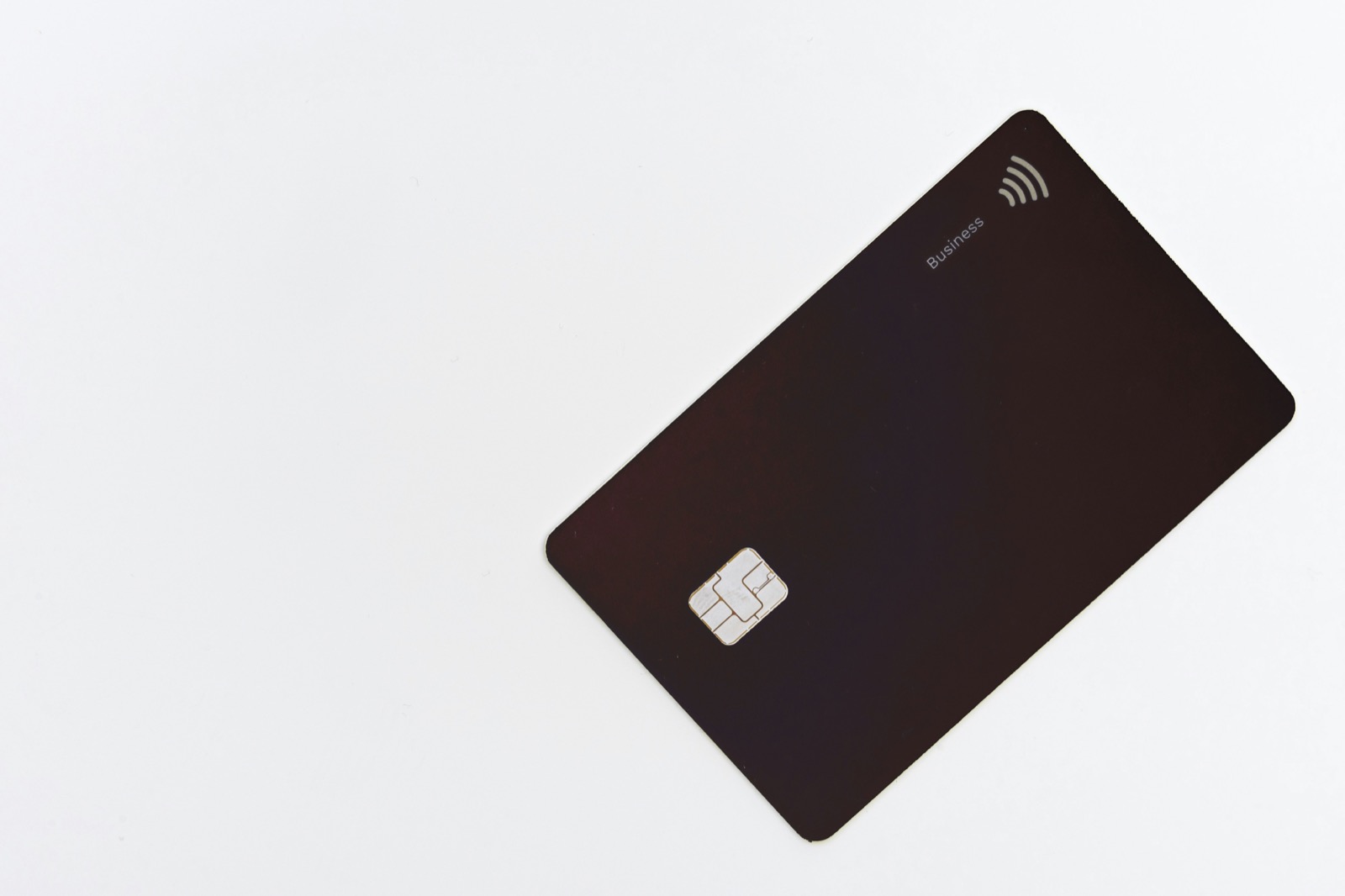 A contactless credit card on a plain white surface